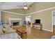Inviting living room with vaulted ceiling, wood floors, a stone fireplace and a ceiling fan at 2416 Hurt Sw Rd, Marietta, GA 30008