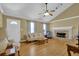 Inviting living room with vaulted ceiling, wood floors, a stone fireplace and a ceiling fan at 2416 Hurt Sw Rd, Marietta, GA 30008