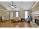 Inviting living room with vaulted ceiling, wood floors, a stone fireplace and a ceiling fan at 2416 Hurt Sw Rd, Marietta, GA 30008