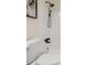 Bathroom showing toilet, white tile walls, black rain shower head and faucet at 6974 Clearlake Ct, Peachtree Corners, GA 30360