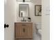 Small bathroom with natural wood cabinet, marble countertop, and black plumbing fixtures at 6974 Clearlake Ct, Peachtree Corners, GA 30360