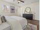 Bright bedroom features a ceiling fan, dark wood floors, neutral walls, and two sun-filled windows at 6974 Clearlake Ct, Peachtree Corners, GA 30360