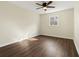 Bedroom features dark wood-look flooring, large window, ceiling fan, and fresh paint at 6974 Clearlake Ct, Peachtree Corners, GA 30360