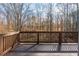 Wooden deck with railing overlooking wooded backyard on a sunny day at 6974 Clearlake Ct, Peachtree Corners, GA 30360