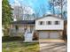 Charming two-story home featuring stone accents, a covered porch, and an attached two-car garage at 6974 Clearlake Ct, Peachtree Corners, GA 30360