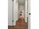 Hallway featuring dark wood-look floors and view of a living room with fireplace at 6974 Clearlake Ct, Peachtree Corners, GA 30360