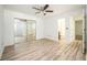 Open bedroom with hardwood floors, ceiling fan and mirrored closets at 1306 Red Deer Way # 246, Alpharetta, GA 30022