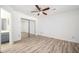 This empty bedroom features a ceiling fan, mirrored closet, and ensuite bath at 1306 Red Deer Way # 246, Alpharetta, GA 30022