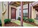 Ground level condo entrance featuring a paneled front door, and tasteful landscaping at 1306 Red Deer Way # 246, Alpharetta, GA 30022