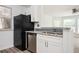 Kitchen featuring stainless steel appliances, granite countertops, and an open layout to the living area at 1306 Red Deer Way # 246, Alpharetta, GA 30022