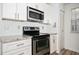 Modern kitchen features stainless steel appliances, white cabinets, and granite countertops at 1306 Red Deer Way # 246, Alpharetta, GA 30022