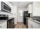 Modern kitchen features granite counters, stainless appliances, and white cabinets at 1306 Red Deer Way # 246, Alpharetta, GA 30022