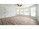 Spacious living room with hardwood floors, a ceiling fan, large window and a front door at 1306 Red Deer Way # 246, Alpharetta, GA 30022