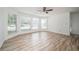 Bright, airy living room featuring large windows, hardwood floors and a ceiling fan at 1306 Red Deer Way # 246, Alpharetta, GA 30022