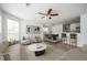 Bright living room with hardwood floors, modern furnishings, ceiling fan, and access to dining area at 1306 Red Deer Way # 246, Alpharetta, GA 30022