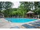 Community pool area with lounge chairs and covered gazebo, perfect for relaxing and entertaining at 1306 Red Deer Way # 246, Alpharetta, GA 30022