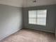 Bright bedroom with large windows, neutral walls, and plush carpeting at 220 Baltimore Ave, Stockbridge, GA 30281