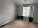 Well-lit bedroom with large windows, neutral walls, and plush carpeting at 220 Baltimore Ave, Stockbridge, GA 30281