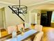 Well-lit dining area featuring contemporary chandelier and a staircase view at 220 Baltimore Ave, Stockbridge, GA 30281