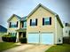 Inviting two-story home featuring a neat lawn, double garage, and a classic suburban design at 220 Baltimore Ave, Stockbridge, GA 30281