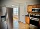 Modern kitchen featuring stainless steel appliances and tile flooring at 220 Baltimore Ave, Stockbridge, GA 30281
