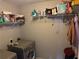 Functional laundry room with washer, dryer, and overhead shelving for storage at 220 Baltimore Ave, Stockbridge, GA 30281