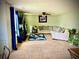 Inviting living room features plush carpeting, ceiling fan, and a comfortable sectional sofa at 220 Baltimore Ave, Stockbridge, GA 30281