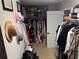 Spacious walk-in closet featuring hats, shoes, and a variety of clothing items at 220 Baltimore Ave, Stockbridge, GA 30281