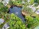 Aerial view of a community pond with a fountain, surrounded by trees and residential homes at 4104 Glenaire Nw Way, Acworth, GA 30101