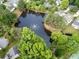 Aerial view of the community lake with a fountain, a bridge, and surrounding homes and greenery at 4104 Glenaire Nw Way, Acworth, GA 30101