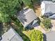 Aerial view of the home surrounded by mature trees and lush landscaping at 4104 Glenaire Nw Way, Acworth, GA 30101