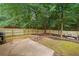 Spacious backyard with a concrete patio, wood fence, and mature trees at 4104 Glenaire Nw Way, Acworth, GA 30101