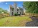 Fenced backyard featuring a well-maintained lawn, mature trees, and a patio, creating a private outdoor space at 4104 Glenaire Nw Way, Acworth, GA 30101
