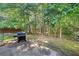 Cozy backyard patio with a grill and shade trees, perfect for enjoying outdoor meals and relaxation at 4104 Glenaire Nw Way, Acworth, GA 30101