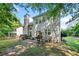 Spacious backyard featuring a patio area, lush greenery, and privacy trees, perfect for outdoor entertaining at 4104 Glenaire Nw Way, Acworth, GA 30101