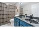 Bathroom with a shower and toilet behind decorative shower curtains at 4104 Glenaire Nw Way, Acworth, GA 30101