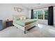 Bright bedroom with neutral decor, large window, and comfortable bed at 4104 Glenaire Nw Way, Acworth, GA 30101