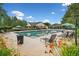 Community pool with lounge chairs and umbrellas, surrounded by greenery and flowers at 4104 Glenaire Nw Way, Acworth, GA 30101