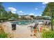 Relaxing community pool area with ample lounge chairs, tables with umbrellas, and lush landscaping at 4104 Glenaire Nw Way, Acworth, GA 30101