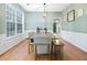 Elegant dining room with large windows, a pendant light, and seating for eight at 4104 Glenaire Nw Way, Acworth, GA 30101