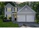 Charming two-story home featuring a two car garage, well-maintained lawn, and inviting front entrance at 4104 Glenaire Nw Way, Acworth, GA 30101