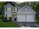 Charming two-story home with a two-car garage, well-maintained lawn, and classic architectural details at 4104 Glenaire Nw Way, Acworth, GA 30101