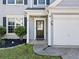Inviting front entrance with a stylish black door, decorative sidelight, and a well-manicured garden bed at 4104 Glenaire Nw Way, Acworth, GA 30101