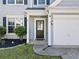 Close up of the main entrance featuring landscaping, a black front door and a two-car garage at 4104 Glenaire Nw Way, Acworth, GA 30101