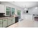 Bright kitchen with updated countertops, black appliances, black subway tile backsplash, and a view to the yard at 4104 Glenaire Nw Way, Acworth, GA 30101