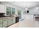 Bright kitchen with granite countertops, modern appliances, and an adjacent sliding glass door at 4104 Glenaire Nw Way, Acworth, GA 30101