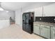 Updated kitchen with stainless steel appliances, granite countertops, and black subway tile backsplash at 4104 Glenaire Nw Way, Acworth, GA 30101