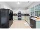 Functional kitchen features light cabinets, updated appliances, and a large window for natural light at 4104 Glenaire Nw Way, Acworth, GA 30101
