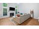 Bright living room with a fireplace, large windows, and a cozy seating arrangement, perfect for relaxation at 4104 Glenaire Nw Way, Acworth, GA 30101