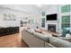 Bright living room with a fireplace, large windows, and a cozy seating arrangement, perfect for relaxation at 4104 Glenaire Nw Way, Acworth, GA 30101